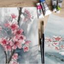 Pinsel, Farben und gemaltes Aquarellbild auf dem Kirschblüten zu sehen sind