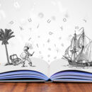 Buch auf Tisch mit visuellen Buchstaben und Illustrationen