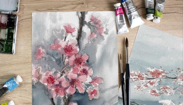 Pinsel, Farben und gemaltes Aquarellbild auf dem Kirschblüten zu sehen sind