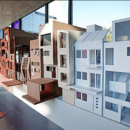 Architekturentwürfe von Studierenden sind in einem Ausstellungsraum zu sehen.