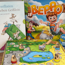 Buch "Die verflixten sieben Geißlein" und Spiel "Beppo"