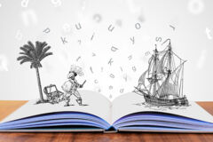 Buch auf Tisch mit visuellen Buchstaben und Illustrationen