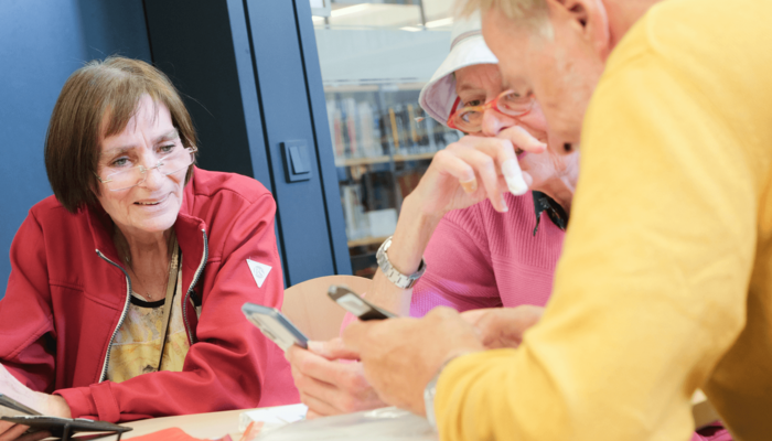 Silber & Smart Workshop wo Person Dinge am Handy erklärt bekommt