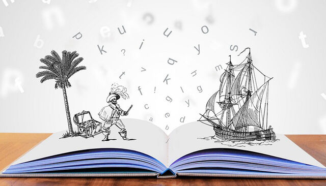 Buch auf Tisch mit visuellen Buchstaben und Illustrationen