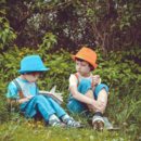 zwei Kinder lesen im Park